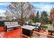 Inviting backyard deck with outdoor seating around a fire pit, surrounded by lush landscaping at 6037 Porter Ln, Noblesville, IN 46062