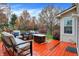 Relaxing backyard deck featuring comfortable seating around a modern fire pit with colorful fall foliage views at 6037 Porter Ln, Noblesville, IN 46062