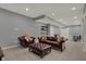 Finished basement offers a comfortable seating area with leather furniture and a home gym setup at 6037 Porter Ln, Noblesville, IN 46062