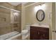 Bathroom featuring a glass-enclosed shower with neutral toned tile, sleek vanity, and modern lighting at 6037 Porter Ln, Noblesville, IN 46062