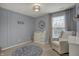 Neutral Bedroom featuring gray walls, a round area rug, and glider at 6037 Porter Ln, Noblesville, IN 46062
