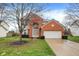 Charming two-story brick home with a well-maintained lawn and attached two-car garage at 6037 Porter Ln, Noblesville, IN 46062