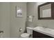 The cozy powder room features a pedestal sink, toilet, and modern mirror at 6037 Porter Ln, Noblesville, IN 46062