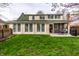 Well-maintained backyard with a lush green lawn, a stone patio, and mature trees at 6041 Garver Rd, Indianapolis, IN 46208
