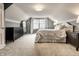 Neutral bedroom features a bed, large window, and dark wood dressers on a neutral carpet at 6041 Garver Rd, Indianapolis, IN 46208