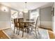 Elegant dining room featuring hardwood floors, modern lighting, and a round wooden table with comfortable seating at 6041 Garver Rd, Indianapolis, IN 46208