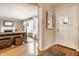 Inviting foyer with hardwood floors, a decorative mirror, and an open view into the living room at 6041 Garver Rd, Indianapolis, IN 46208