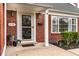 Close up of the front entrance, highlighting the house number, covered porch, and well-maintained landscaping at 6041 Garver Rd, Indianapolis, IN 46208