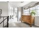 Charming hallway with french doors and a vintage dresser, complemented by a bright window at 6041 Garver Rd, Indianapolis, IN 46208