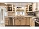 Kitchen boasts stainless appliances, granite counters, and a window over the sink overlooking the backyard at 6041 Garver Rd, Indianapolis, IN 46208