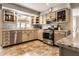 Well-lit kitchen featuring stainless steel appliances, granite countertops, and ample cabinet space at 6041 Garver Rd, Indianapolis, IN 46208