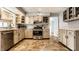 Bright eat-in kitchen showcasing stainless steel appliances and stylish flooring at 6041 Garver Rd, Indianapolis, IN 46208