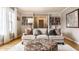 Comfortable living room with neutral decor, plush seating, large windows, and built-in bookshelves at 6041 Garver Rd, Indianapolis, IN 46208
