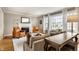 Cozy living room featuring a fireplace, leather chairs, neutral tones, and large window at 6041 Garver Rd, Indianapolis, IN 46208