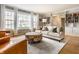 Bright and airy living room with large windows, comfortable seating, and stylish built-in bookshelves at 6041 Garver Rd, Indianapolis, IN 46208