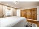 Comfortable main bedroom with wood accent wall, plush carpeting, and ample natural light at 6041 Garver Rd, Indianapolis, IN 46208
