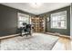 Bright home office with custom built-in bookshelves and large windows for plenty of natural light at 6041 Garver Rd, Indianapolis, IN 46208