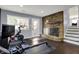 Finished basement features a stone fireplace and hearth, exercise equipment, and plenty of natural light at 6377 Green Leaves Rd, Indianapolis, IN 46220