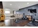 Spacious finished basement with comfortable seating, exercise area, and built-in shelving at 6377 Green Leaves Rd, Indianapolis, IN 46220