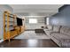 Finished basement with stylish decor, plush sectional, and built-in storage solutions at 6377 Green Leaves Rd, Indianapolis, IN 46220