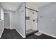 Modern bathroom with a large glass enclosed shower, dark tile floor, and cool gray walls at 6377 Green Leaves Rd, Indianapolis, IN 46220