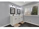 Modern bathroom with a double vanity, stylish mirrors, and natural light from the window at 6377 Green Leaves Rd, Indianapolis, IN 46220