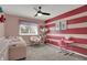 Stylish bedroom with unique wall decor, comfortable seating, and bright accents at 6377 Green Leaves Rd, Indianapolis, IN 46220