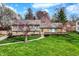 Beautifully landscaped home with a stone and siding exterior and a lush green lawn at 6377 Green Leaves Rd, Indianapolis, IN 46220