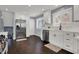 Modern kitchen with white cabinets, stainless steel appliances, and hardwood flooring at 6377 Green Leaves Rd, Indianapolis, IN 46220