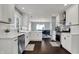 Bright, updated kitchen with stainless steel appliances, white cabinetry, and dark wood floors at 6377 Green Leaves Rd, Indianapolis, IN 46220