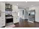Bright kitchen with white cabinets, stainless steel appliances, and designer backsplash at 6377 Green Leaves Rd, Indianapolis, IN 46220