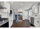Bright kitchen with white cabinets, stainless steel appliances, and dark hardwood floors at 6377 Green Leaves Rd, Indianapolis, IN 46220