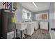 Bright laundry room equipped with modern washer, dryer, utility sink, and ample storage at 6377 Green Leaves Rd, Indianapolis, IN 46220