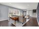 Open-concept living room with hardwood floors, large windows, and stylish furniture at 6377 Green Leaves Rd, Indianapolis, IN 46220