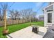 Fenced backyard with patio, string lights and a fire pit table offers a cozy and private outdoor space for relaxation and entertainment at 6557 Eagles Nest Ln, McCordsville, IN 46055