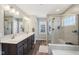 Bathroom featuring double vanity, frameless shower, soaking tub, and modern fixtures at 6557 Eagles Nest Ln, McCordsville, IN 46055
