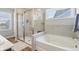 Bathroom featuring frameless shower, soaking tub, and tile flooring at 6557 Eagles Nest Ln, McCordsville, IN 46055