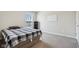 This cozy bedroom features neutral walls, a window, and carpeted flooring at 6557 Eagles Nest Ln, McCordsville, IN 46055