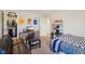 This bedroom features a futon, a tv, decor, and access to a walk-in closet at 6557 Eagles Nest Ln, McCordsville, IN 46055