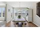 Dining room with a farmhouse table and bench seating, adjacent to an exterior door and windows at 6557 Eagles Nest Ln, McCordsville, IN 46055