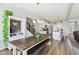 Dining area featuring a long wooden table with seating and stylish lighting fixtures at 6557 Eagles Nest Ln, McCordsville, IN 46055