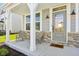 Inviting covered front porch with seating area, providing a cozy outdoor space and stylish entryway at 6557 Eagles Nest Ln, McCordsville, IN 46055