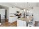 Open kitchen with white cabinets, granite countertops, stainless steel appliances, and a center island with seating at 6557 Eagles Nest Ln, McCordsville, IN 46055