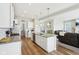 Modern kitchen with a large island, white cabinetry, and stainless steel appliances, open to the living area at 6557 Eagles Nest Ln, McCordsville, IN 46055