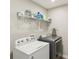 This laundry room features a washer and dryer, with a storage shelf above at 6557 Eagles Nest Ln, McCordsville, IN 46055