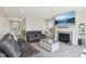 Cozy living room with a gray stone fireplace, a TV, and comfortable leather seating at 6557 Eagles Nest Ln, McCordsville, IN 46055