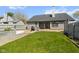 View of the backyard with a patio, green grass, and an in-ground pool at 760 Sable Ridge Dr, Greenwood, IN 46142
