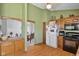 Functional kitchen layout with wood cabinets, modern appliances, and seamless dining room access at 760 Sable Ridge Dr, Greenwood, IN 46142