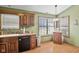 Eat-in kitchen area features wood cabinets, ample counter space, and natural light at 760 Sable Ridge Dr, Greenwood, IN 46142