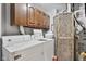 Functional laundry area with wooden cabinets and appliances at 760 Sable Ridge Dr, Greenwood, IN 46142